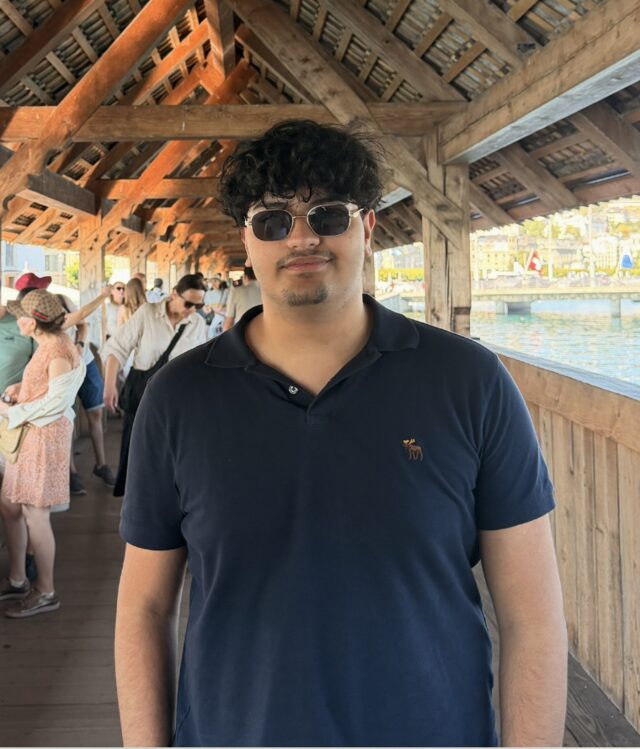 Ahmed Imran in sunglasses and a navy polo shirt